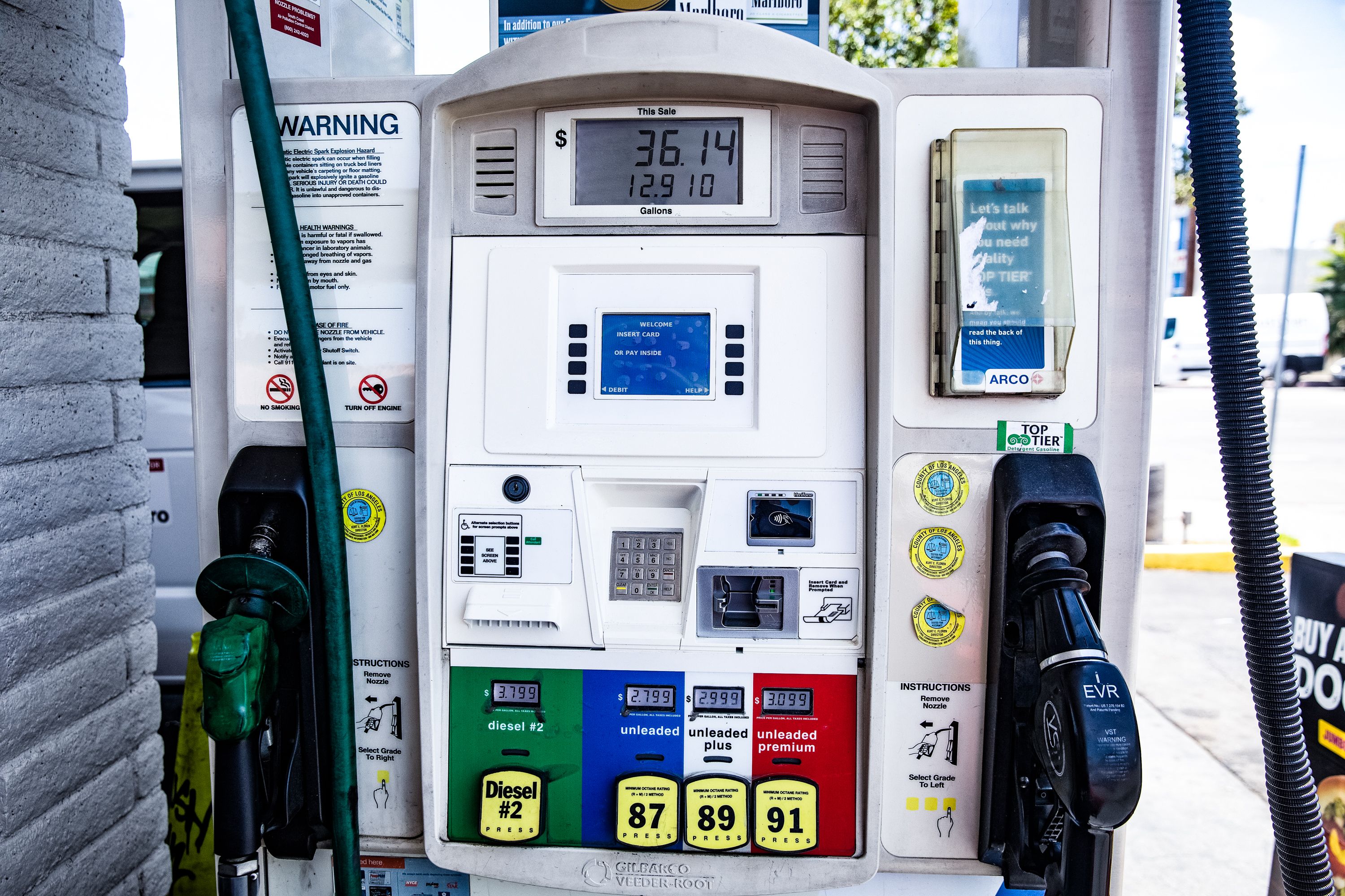 Close-up of gas pump grade buttons showing 87, 89, and 91 octane